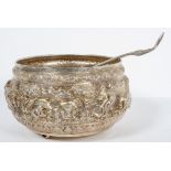 An Asian white metal punch bowl, heavily repousse and chased,