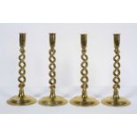A set of four early 20th century brass open twist candlesticks,