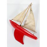 A Star Yacht (Birkenhead) pond yacht, painted in red, with collapsible sail, stamped 'Star/SY/2',