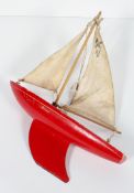 A Star Yacht (Birkenhead) pond yacht, painted in red, with collapsible sail, stamped 'Star/SY/2',