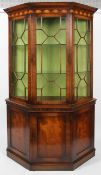 A reproduction George III style mahogany glazed display cabinet, of canted D-section,