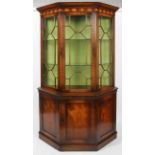 A reproduction George III style mahogany glazed display cabinet, of canted D-section,