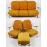 An Ercol pale beech three seater 'Windsor' sofa, two armchairs and a foot stool, with stick backs,