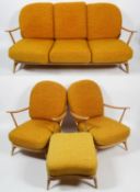 An Ercol pale beech three seater 'Windsor' sofa, two armchairs and a foot stool, with stick backs,