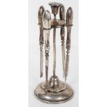 A loaded silver four piece manicure set, on stand, Birmingham 1902,