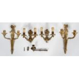 Two pairs of gilt metal twin wall lights, 20th century, the first of neo-Classical form,