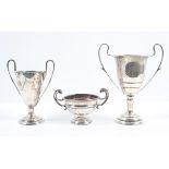 A silver two handled trophy, of traditional form, on a trumpet foot, with ribbon reed decoration,