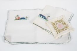 A collection of early to mid 20th century embroidered linen place mats,