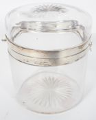 A silver mounted glass biscuit barrel, of plain cylindrical form, with a star cut cover and base,