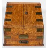 A Victorian oak brass bound stationery box, of sloping hinged section, revealing a calendar,