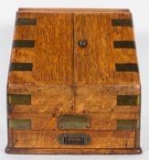 A Victorian oak brass bound stationery box, of sloping hinged section, revealing a calendar,