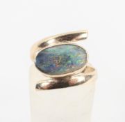 A single stone ring set with an oval cabochon opal.