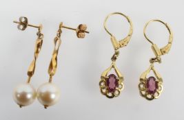 A yellow metal pair of drop earrings set with an oval pink stone; NB: Tests inconclusive.
