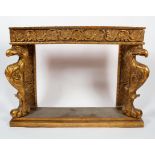 A gilt wood console table, in the manner of William Kent, with two eagle mono podae,