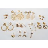 A collection of eight pairs of earrings of variable designs, together with three single earrings.