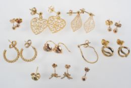 A collection of eight pairs of earrings of variable designs, together with three single earrings.