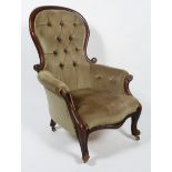 A Victorian mahogany button back armchair, with scroll cresting to balloon back,