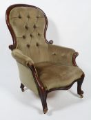 A Victorian mahogany button back armchair, with scroll cresting to balloon back,