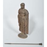 A cast iron fire companion set cast as a Roman Centurion stand, his plumed helmet forming a poker,