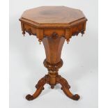 A mid 19th century walnut work table on tripod base with cabriole legs carved with cabrioles