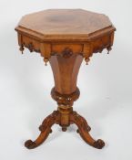 A mid 19th century walnut work table on tripod base with cabriole legs carved with cabrioles