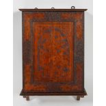An Art Nouveau cut pokerwork wall cabinet, the door decorated with foliate sprays,