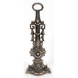 A cast iron doorstop, cast with Greek-key beading and acanthus motifs on stepped plinth,
