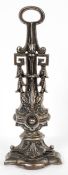 A cast iron doorstop, cast with Greek-key beading and acanthus motifs on stepped plinth,