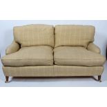 A Howard and Son style loose cushion three seater sofa with double hipped back and low arms to a