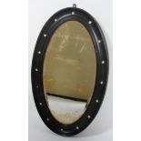 An Irish mirror, in the George III style, with ebonised reeded recessed oval frame,