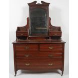 A Victorian mahogany dressing table, circa 1880, centred by an arched rectangular mirror,