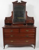 A Victorian mahogany dressing table, circa 1880, centred by an arched rectangular mirror,