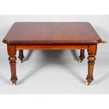 A Victorian mahogany D-section extendable dining room table with two additional leaves,