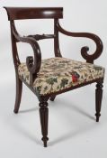 A Victorian mahogany armchair, with curved top rail,