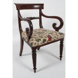 A Victorian mahogany armchair, with curved top rail,