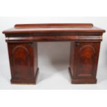 A Victorian mahogany sideboard, with three cushion shaped frieze drawers, with short gallery back,