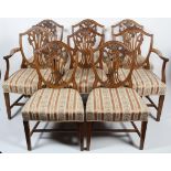 A set of eight George III style Hepplewhite mahogany dining chairs with shield shaped backs,