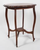 An Edwardian shaped mahogany occasional table with four cabriole legs stretchered to a centre shelf