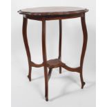 An Edwardian shaped mahogany occasional table with four cabriole legs stretchered to a centre shelf