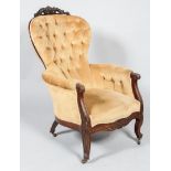 A Victorian button back armchair,