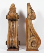 A pair of large carved wood scroll brackets, with acanthus husks and foliate medallions,