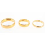 A collection of three wedding rings; 3.0mm / 5.00mm / 5.60mm Size range from K to W.