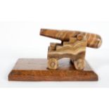 An Edwardian carved onyx model of a canon on oak rectangular stand, early 20th century,