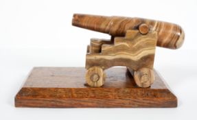 An Edwardian carved onyx model of a canon on oak rectangular stand, early 20th century,