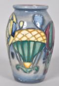 A small Moorcroft 'Balloons' pattern vase of ovoid form decorated with tubelined balloons on a blue