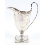 A silver helmet form cream jug with strap handle on a square pedestal foot, Chester 1864, 15cm high,