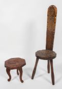 A carved elm spinning chair, together with a carved wood foot stool, the first stamped 'TA261HDHA',