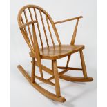 An Ercol child's rocking chair, stamped FL82,