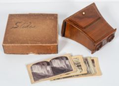 A wooden Stereoscope viewer, of slightly flaring form, and a collection of 30 slides,