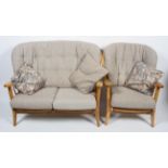 An Ercol pale beech 'Windsor' two seater sofa and an armchair,